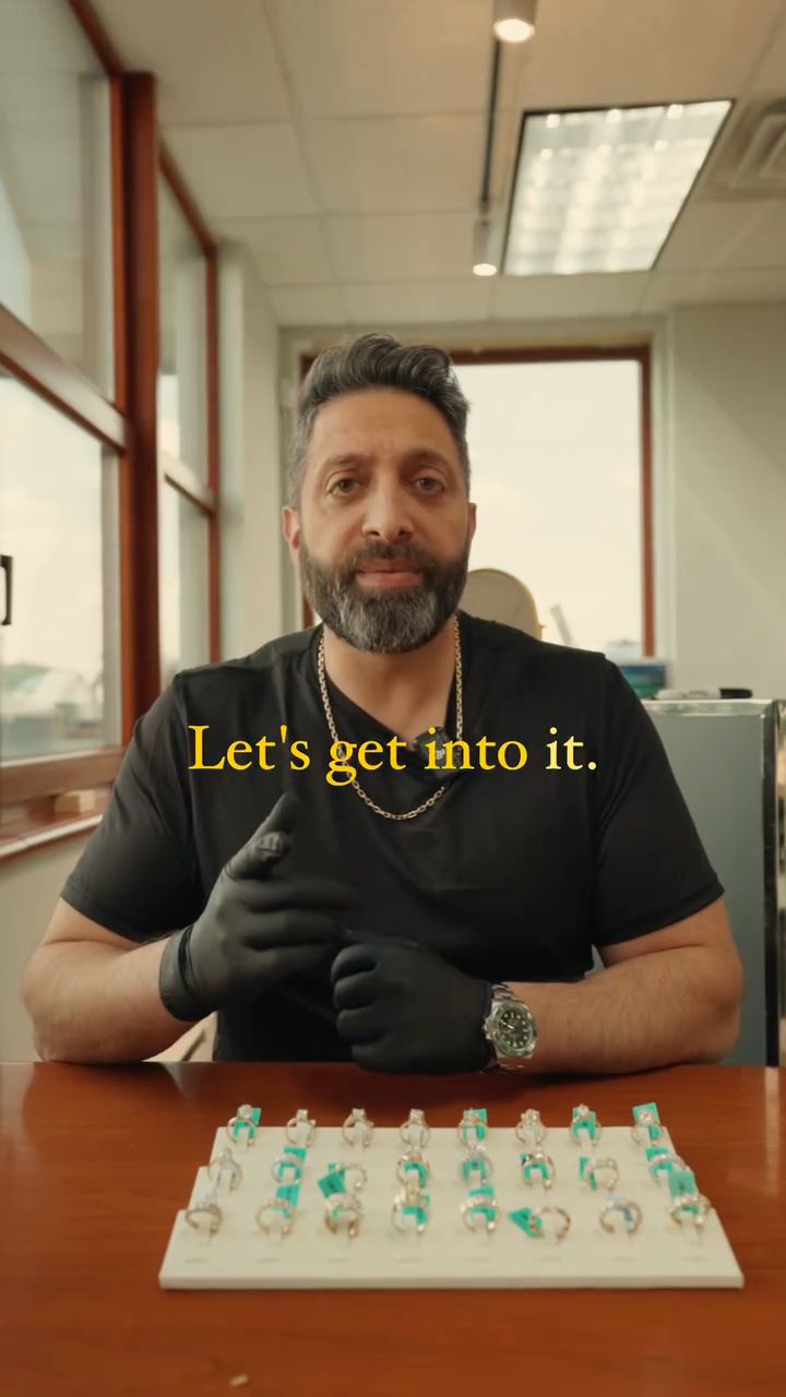 Asmar behind the counter with a tray of diamond rings